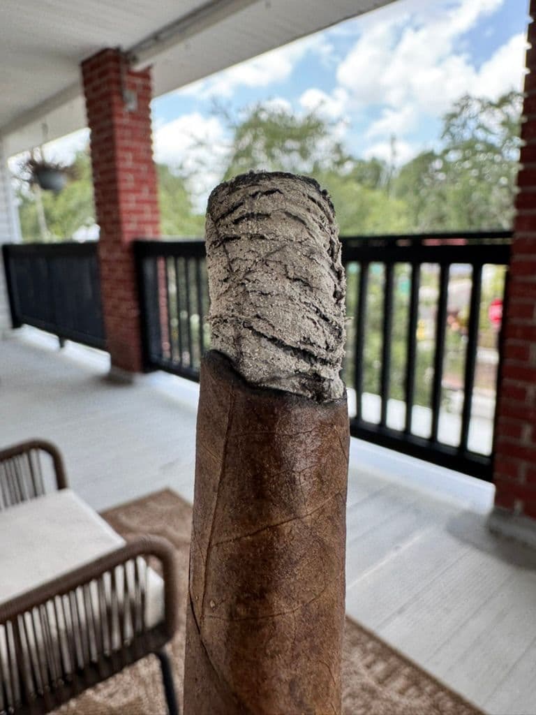 Long ash tower on Création Liberté over a balcony railing