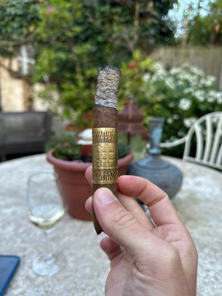 Meerapfel Meir Pyramid mid-smoke on a patio with wine glass and solid white ash