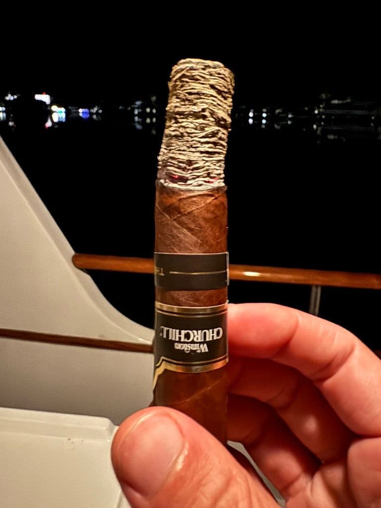 Late Hour Robusto with long solid ash and Winston Churchill band at night