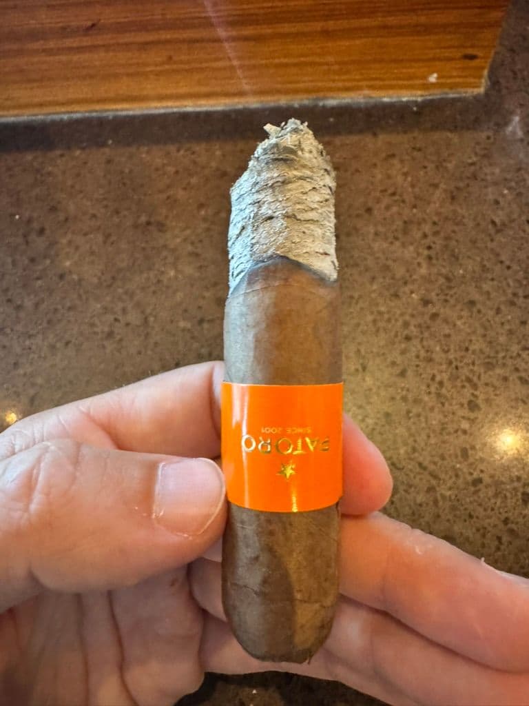 Patoro Serie P Robusto mid-smoke with orange Since 2001 band and flaky ash