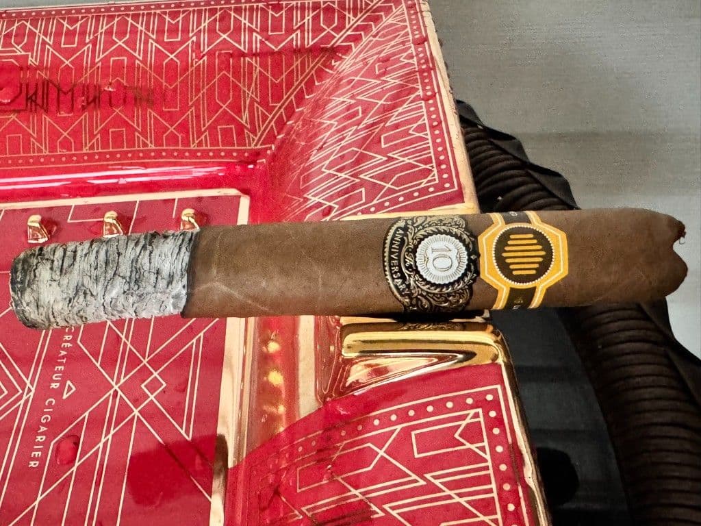 La Colmena 10th Anniversary resting on a red and gold ashtray with V-cut